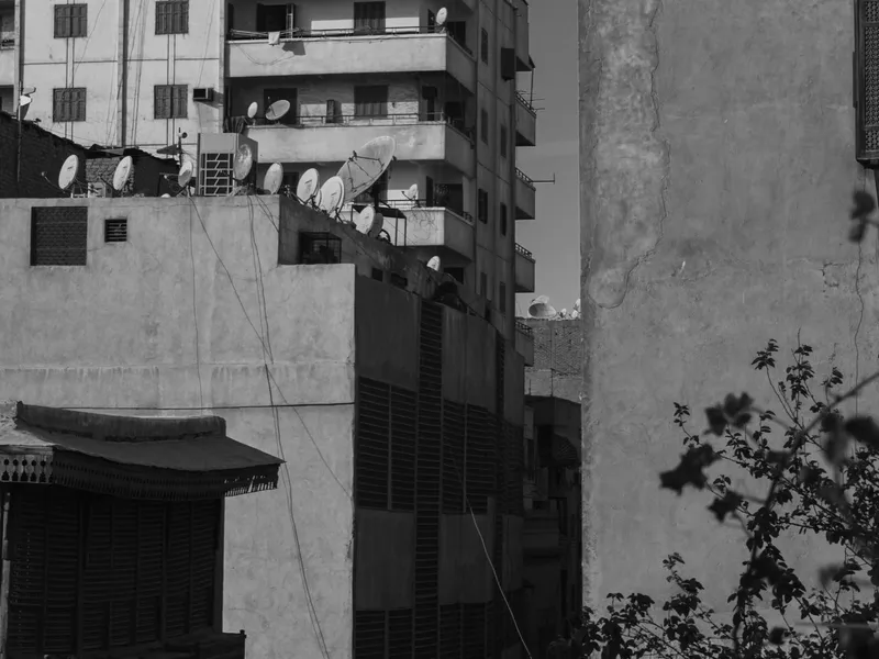 Cairo rooftops stacked into the distance, black and white