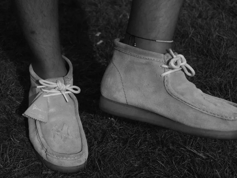 A pair of suede shoes on grass, shot from above