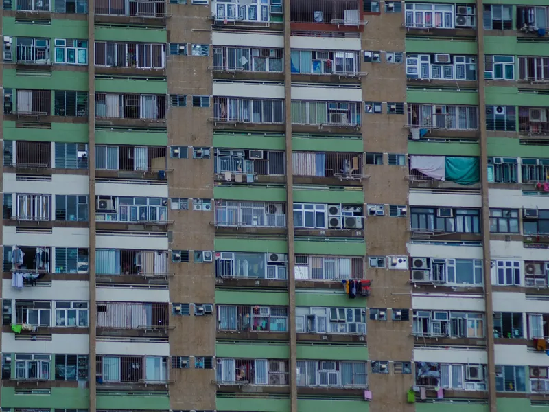 The dense window grid of a Hong Kong apartment block filling the frame