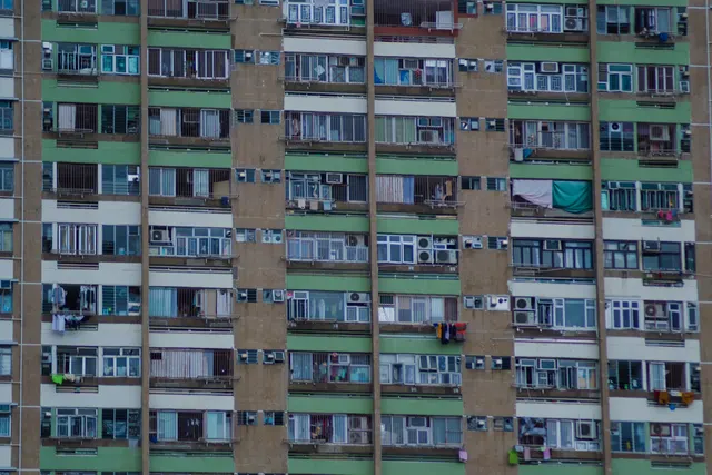The dense window grid of a Hong Kong apartment block filling the frame