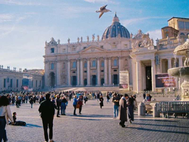 A bird in flight over St Peter's Square, the basilica dome and crowds below